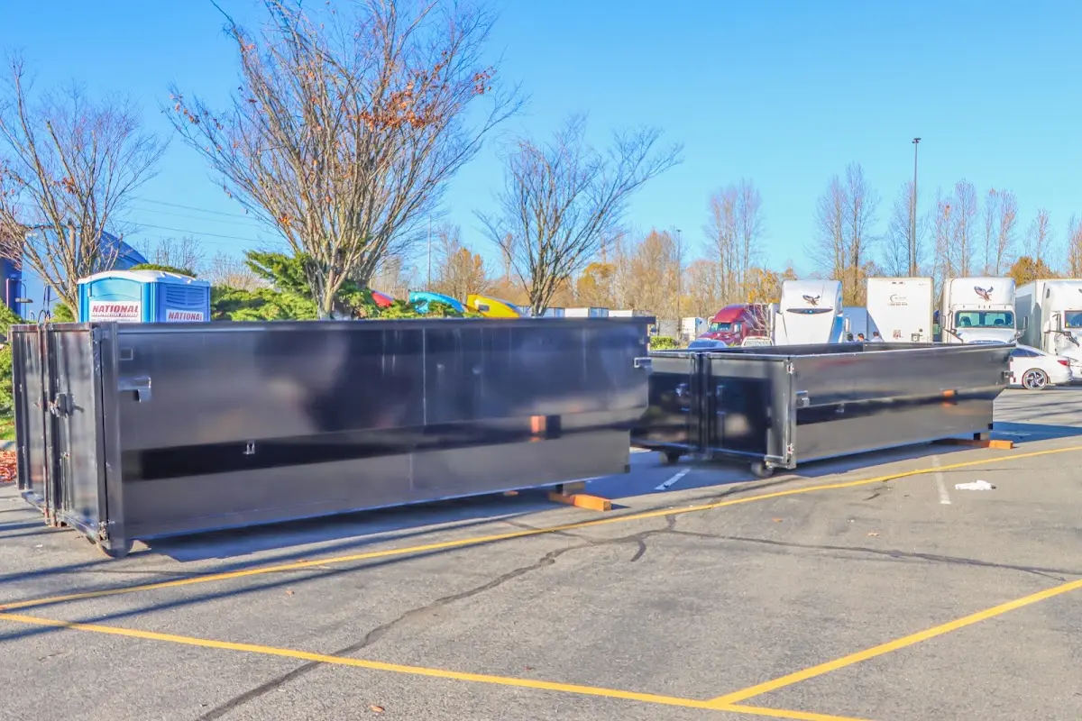 Professional dumpster rental service with roll-off container on residential driveway in Ann Arbor